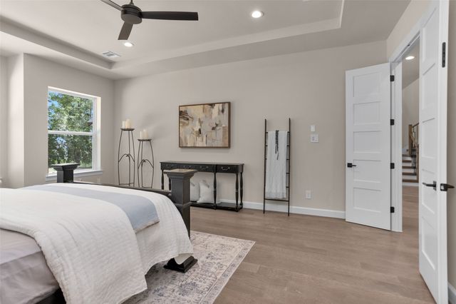 a spacious bedroom with a bed and a window