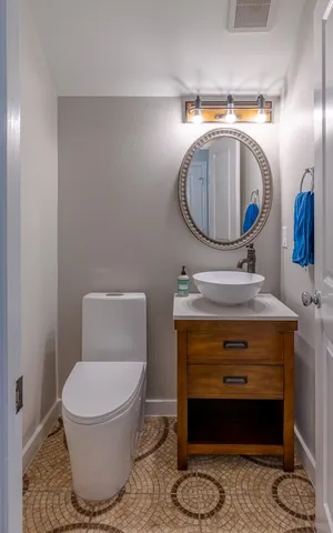 a bathroom with a toilet and a mirror