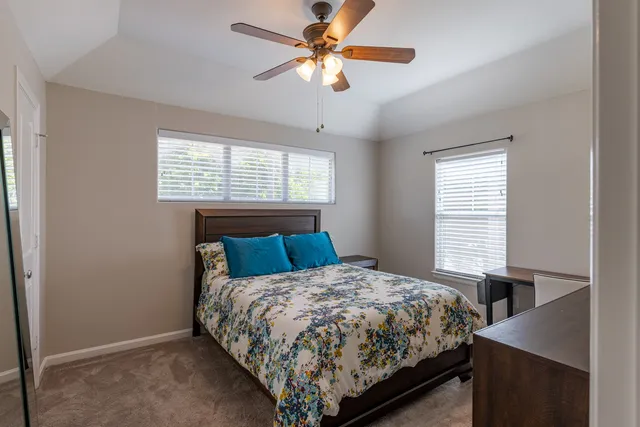 a bed sitting in a bedroom next to a window