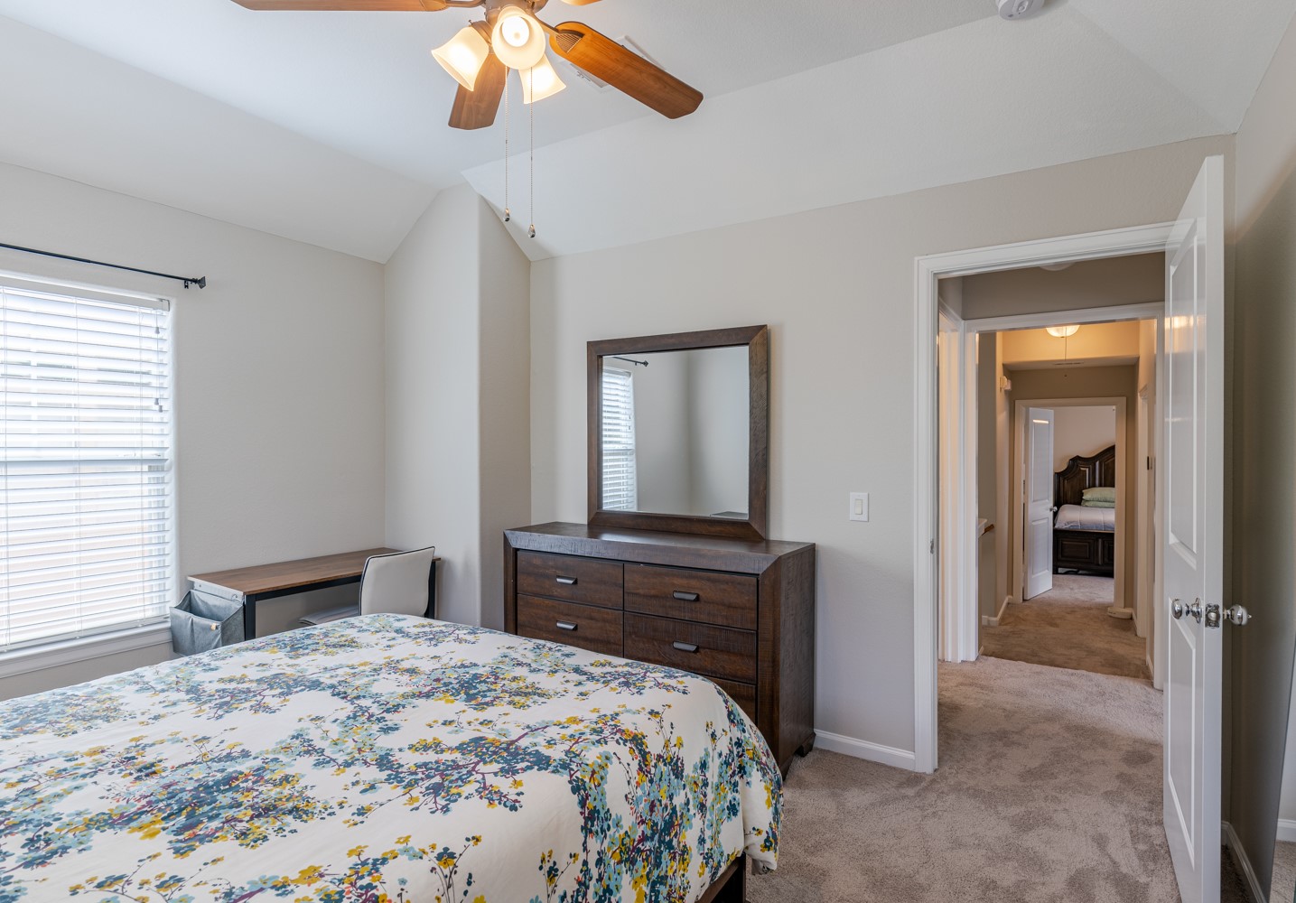 5208 Petty Street, Unit D Houston, TX 77007 - Photo 20 of 39 a bedroom with a bed and a chandelier