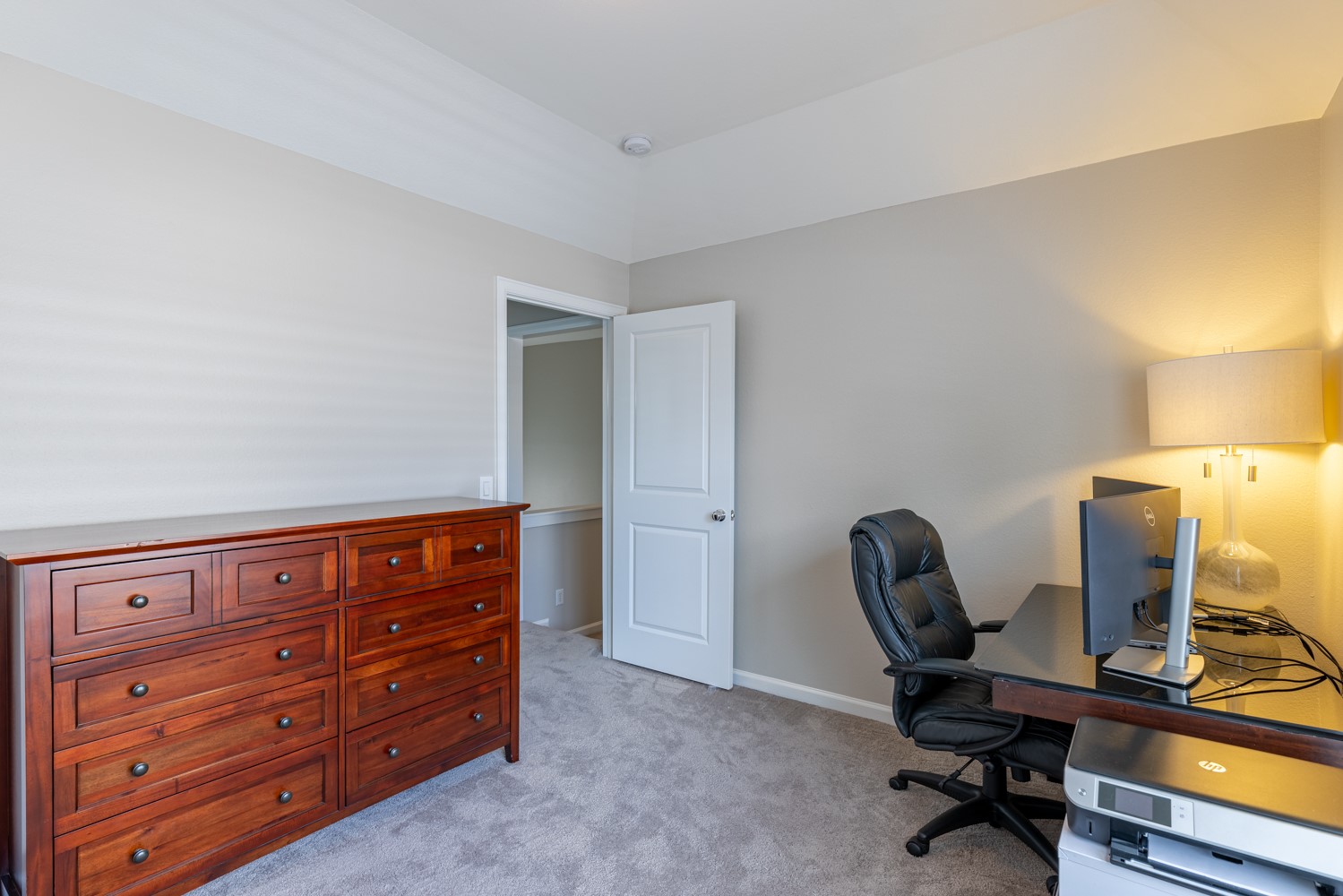 5208 Petty Street, Unit D Houston, TX 77007 - Photo 22 of 39 a view of a workspace with furniture and a lamp