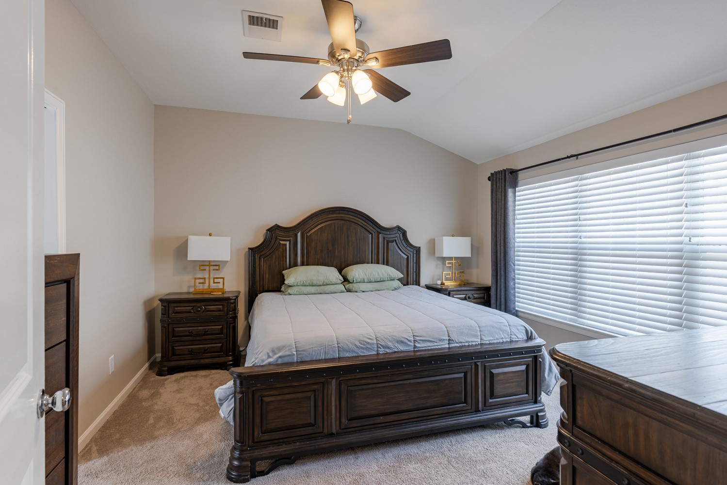 5208 Petty Street, Unit D Houston, TX 77007 - Photo 24 of 39 a bedroom with a bed and a chandelier
