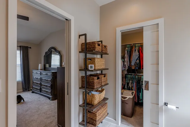 a view of walk in closet with clothes and shoes