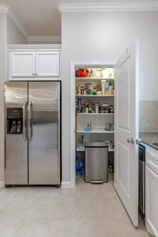 a kitchen with refrigerator and microwave