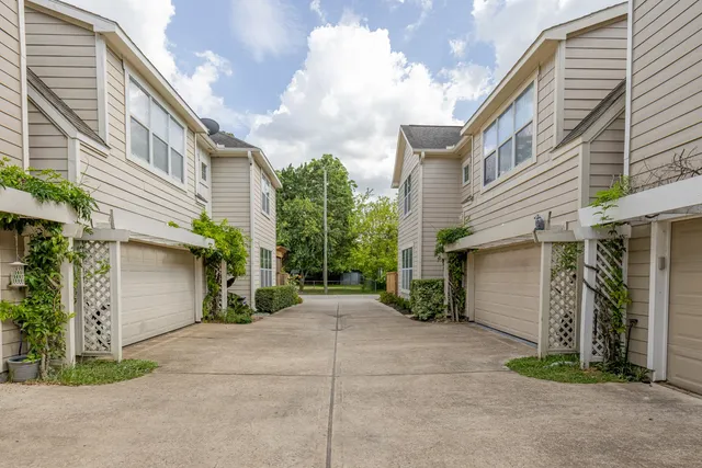 a view of a house with a yard and garage