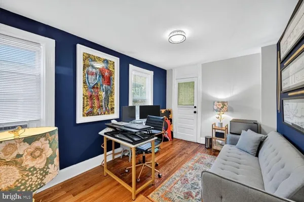 a bedroom with a bed and a flat tv screen on dresser