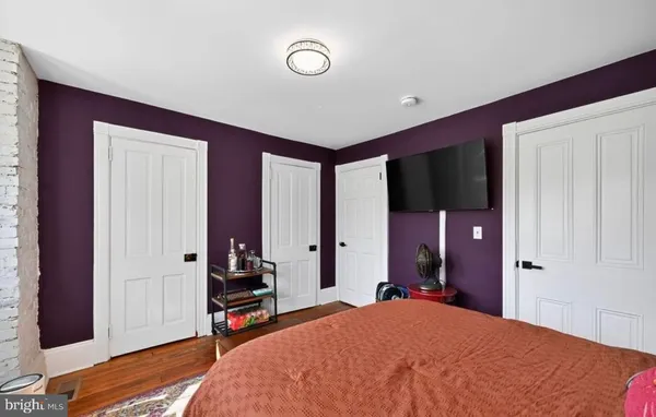 a living room with furniture a flat screen tv and a floor to ceiling window