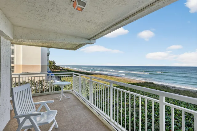 a view of a chairs and table in the balcony