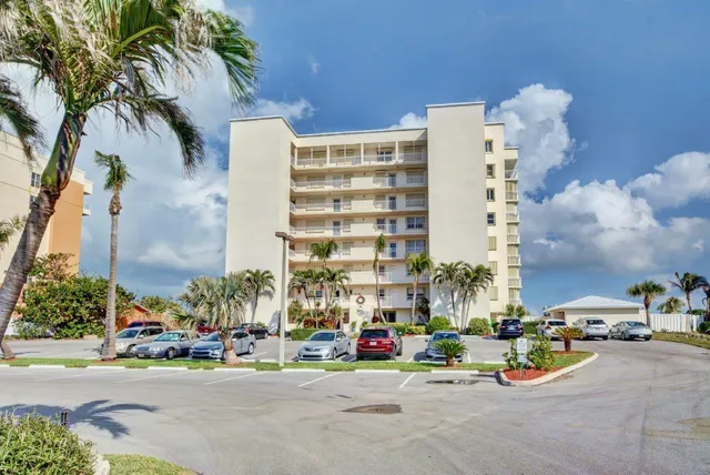 front view of a building with cars parked