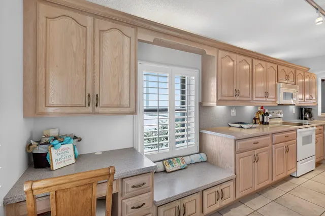 a kitchen with stainless steel appliances granite countertop a sink dishwasher stove and cabinets