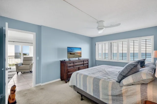 a spacious bedroom with a bed and wooden floor