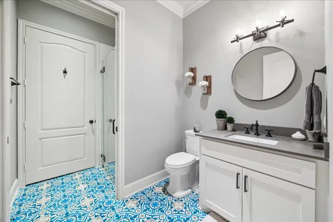a bathroom with a sink a toilet and a mirror