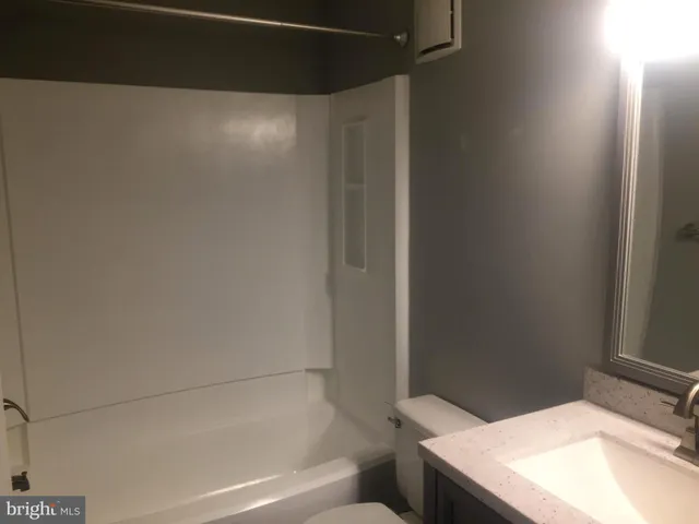 an empty room with wooden floor and a window