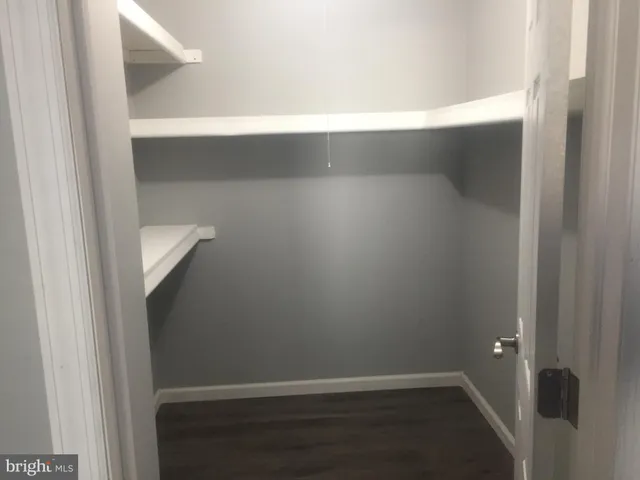 an empty room with wooden floor and door