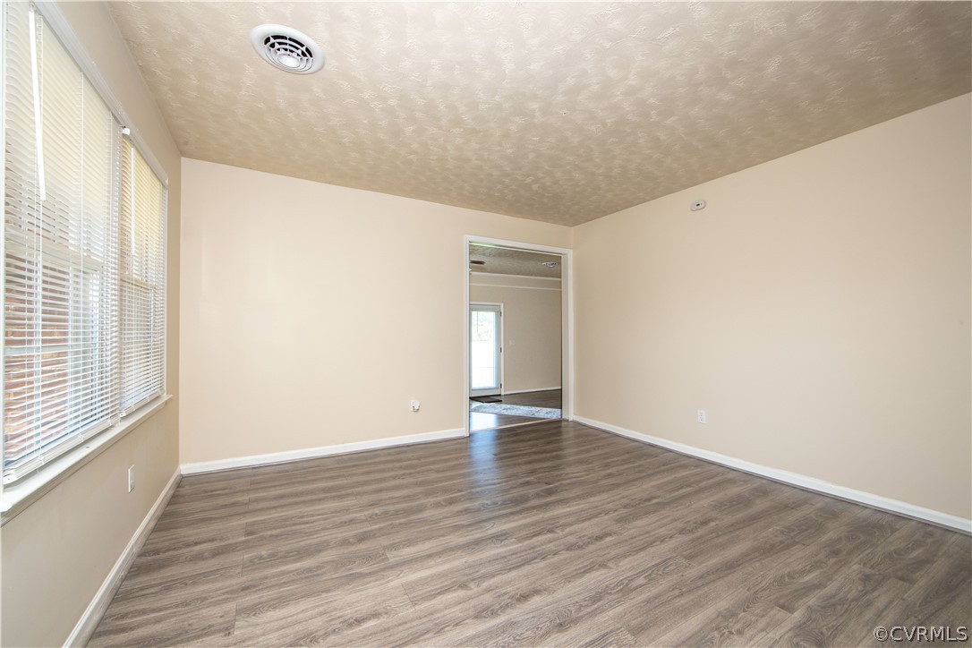 12207 Baltimore Road Ford, VA 23850 - Photo 11 of 24 a view of an empty room with wooden floor and a window