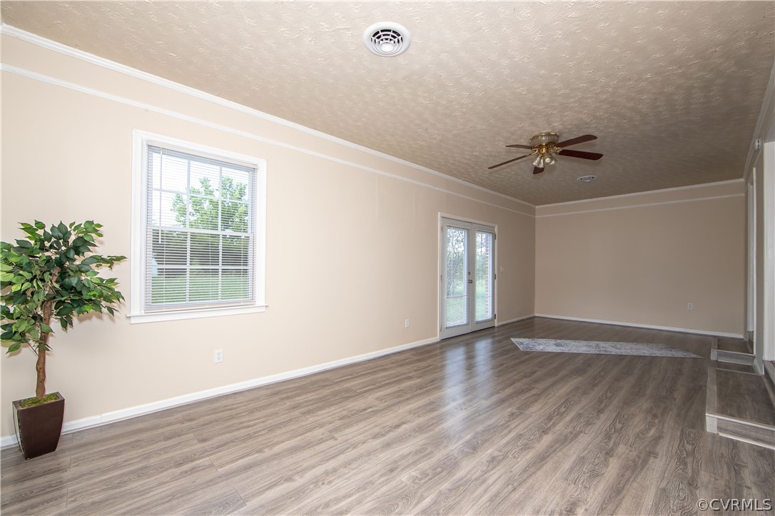 12207 Baltimore Road Ford, VA 23850 - Photo 14 of 24 a view of an empty room with a window and wooden floor