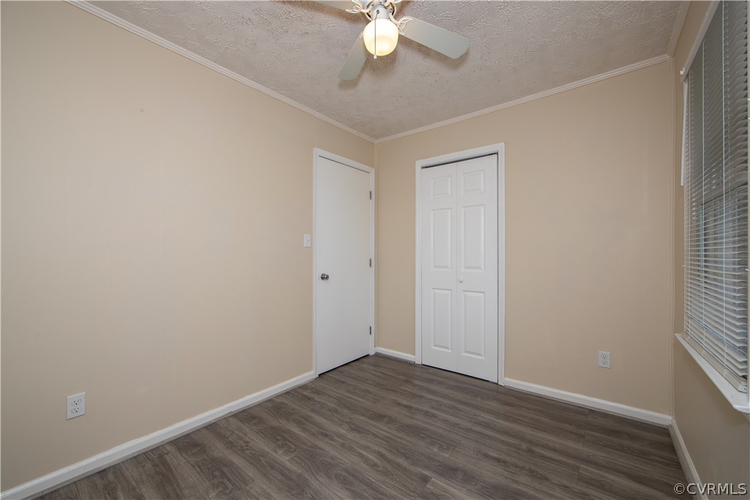 12207 Baltimore Road Ford, VA 23850 - Photo 16 of 24 an empty room with wooden floor and fan