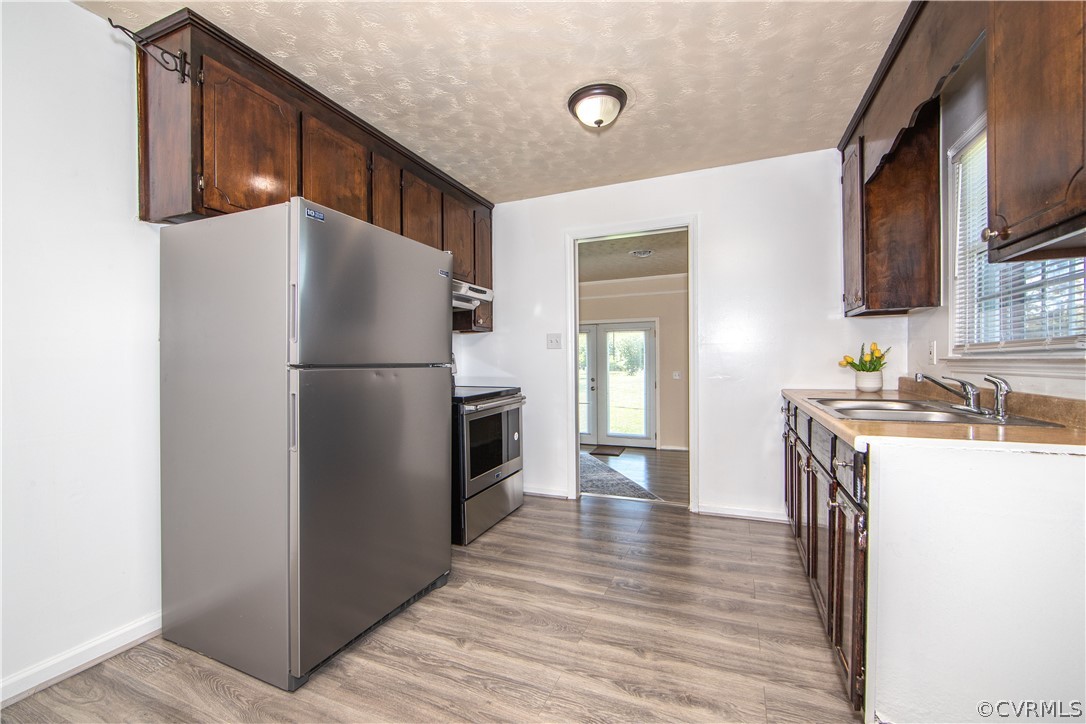 12207 Baltimore Road Ford, VA 23850 - Photo 8 of 24 a kitchen with a refrigerator a stove top oven a sink and dishwasher