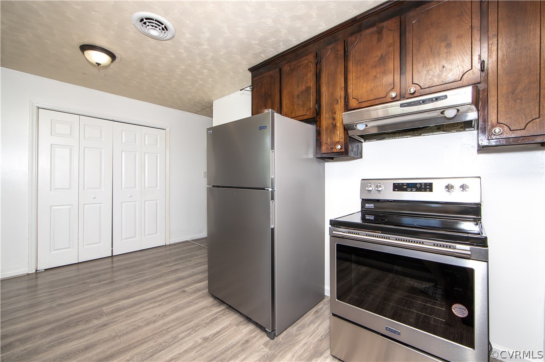 12207 Baltimore Road Ford, VA 23850 - Photo 9 of 24 a kitchen with wooden cabinets and a stove top oven