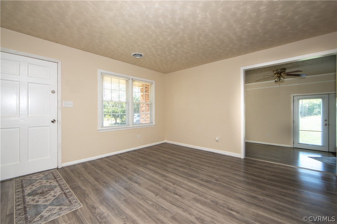 12207 Baltimore Road Ford, VA 23850 - Photo 10 of 24 a view of an empty room with window and wooden floor