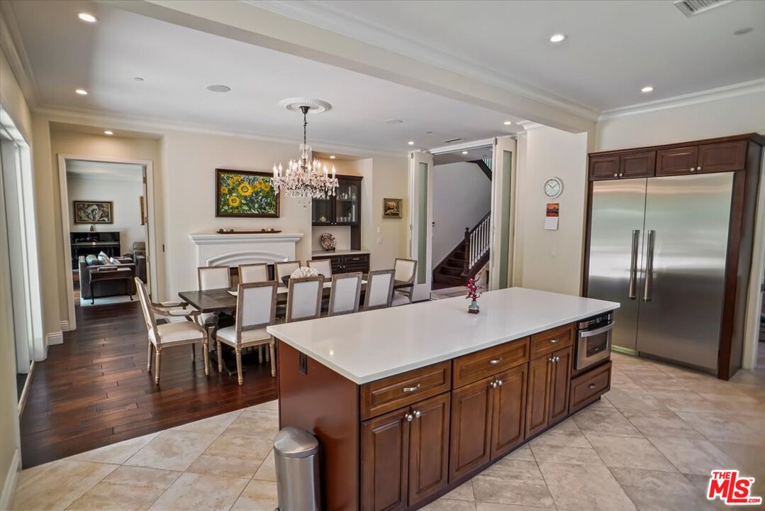 1701 Roscomare Road Los Angeles, CA 90077 - Photo 14 of 45 a large kitchen with kitchen island a island a sink a stove and chairs