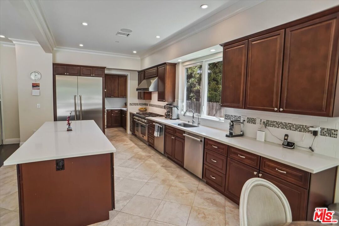 1701 Roscomare Road Los Angeles, CA 90077 - Photo 15 of 45 a large kitchen with kitchen island a sink stainless steel appliances and cabinets