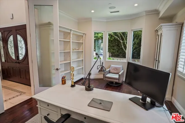 a living room with furniture mirror and a large window