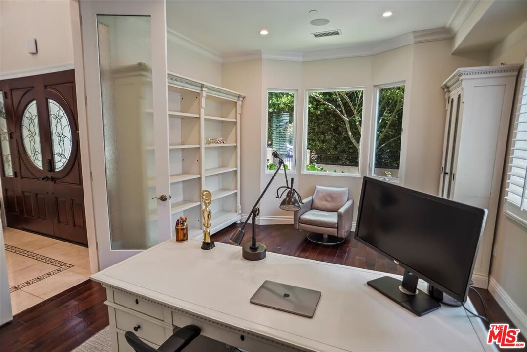 1701 Roscomare Road Los Angeles, CA 90077 - Photo 18 of 45 a living room with furniture mirror and a large window