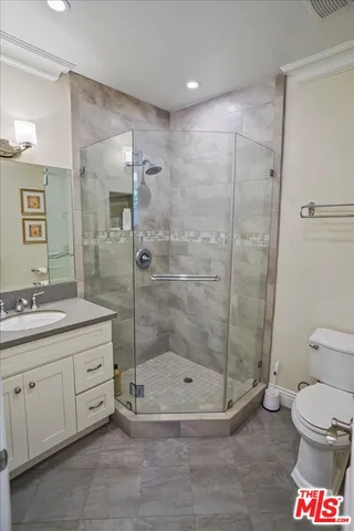 a bathroom with a toilet sink and shower