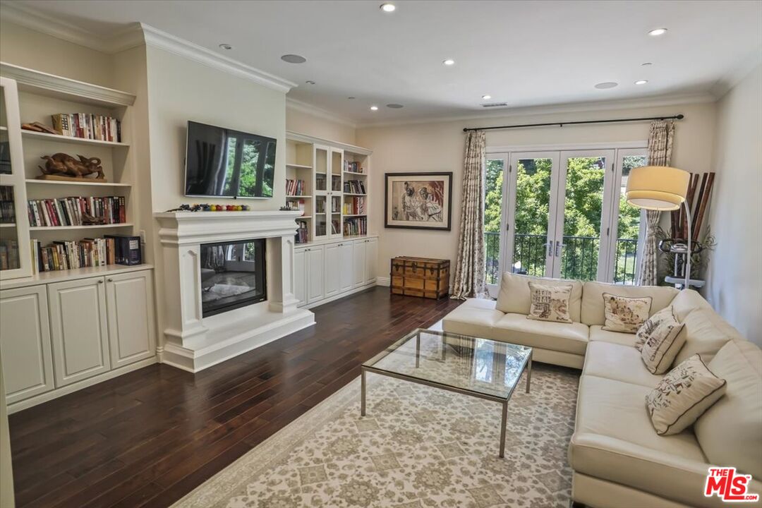 1701 Roscomare Road Los Angeles, CA 90077 - Photo 28 of 45 a living room with furniture large window and a fireplace