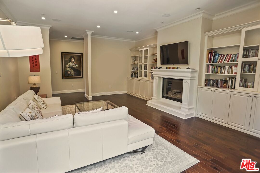 1701 Roscomare Road Los Angeles, CA 90077 - Photo 29 of 45 a living room with furniture a flat screen tv and a fireplace