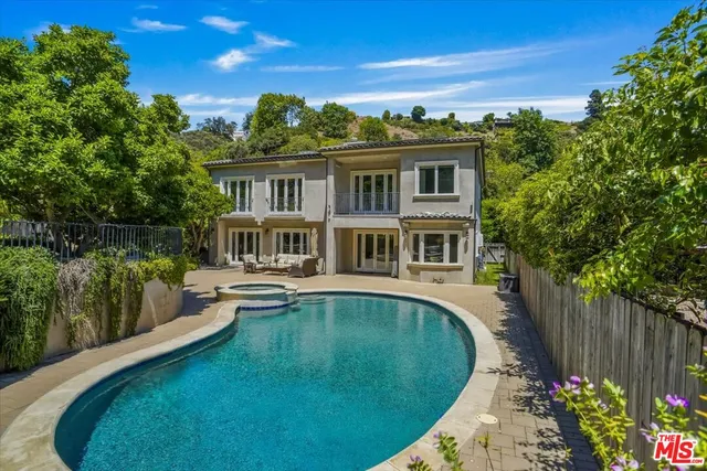 a front view of a house with swimming pool having outdoor seating