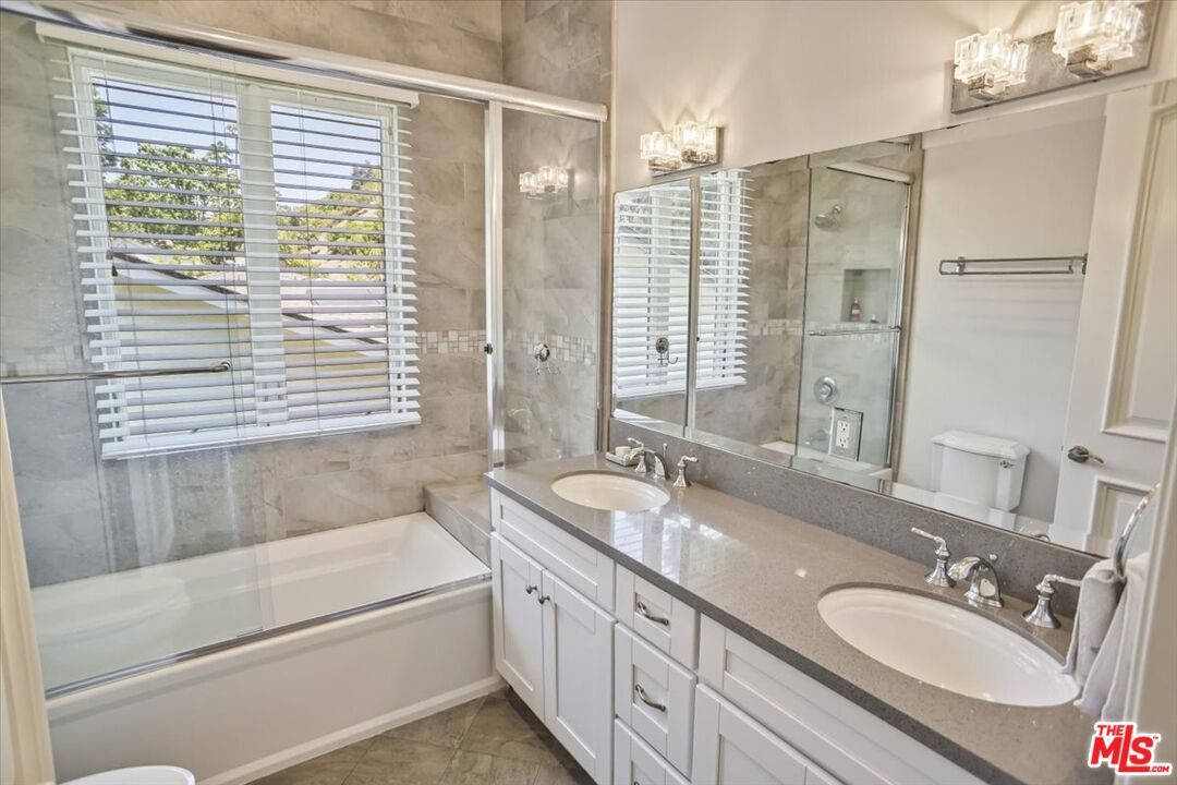 1701 Roscomare Road Los Angeles, CA 90077 - Photo 31 of 45 a bathroom with a granite countertop sink and a bathtub