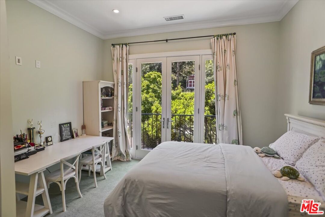 1701 Roscomare Road Los Angeles, CA 90077 - Photo 32 of 45 a bedroom with a bed and a table