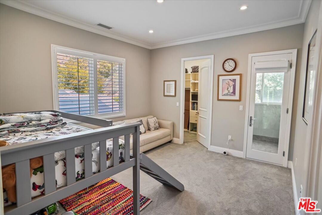 1701 Roscomare Road Los Angeles, CA 90077 - Photo 33 of 45 a bedroom with furniture and a window