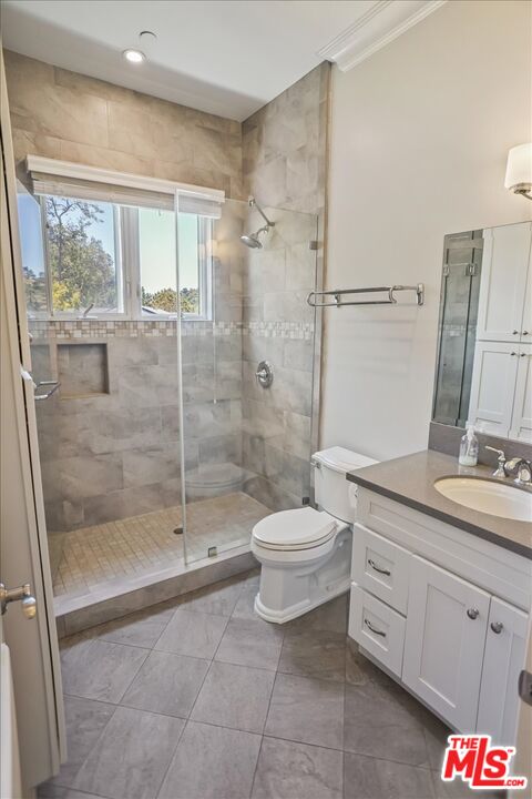 1701 Roscomare Road Los Angeles, CA 90077 - Photo 34 of 45 a bathroom with a granite countertop sink a toilet and shower