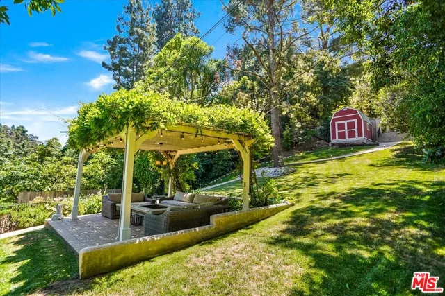 a view of a swimming pool with a patio and a yard