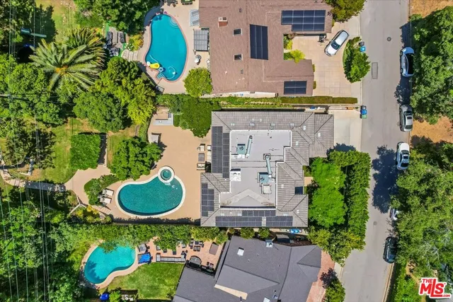 an aerial view of a house with garden space and street view