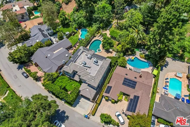 an aerial view of a house with a yard basket ball court and outdoor seating