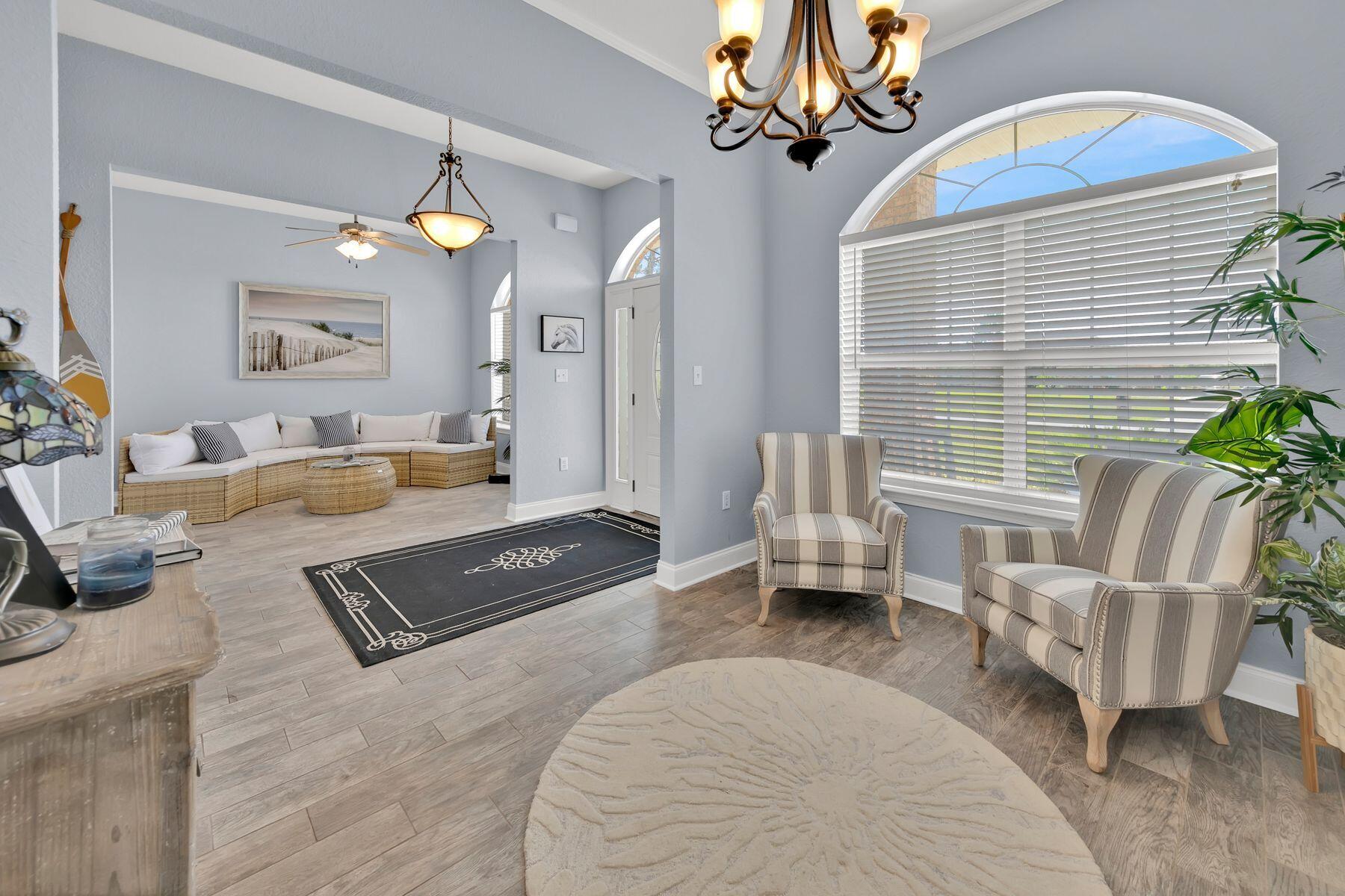 552 East Shipwreck Road Santa Rosa Beach, FL 32459 - Photo 7 of 38 a living room with furniture and a chandelier