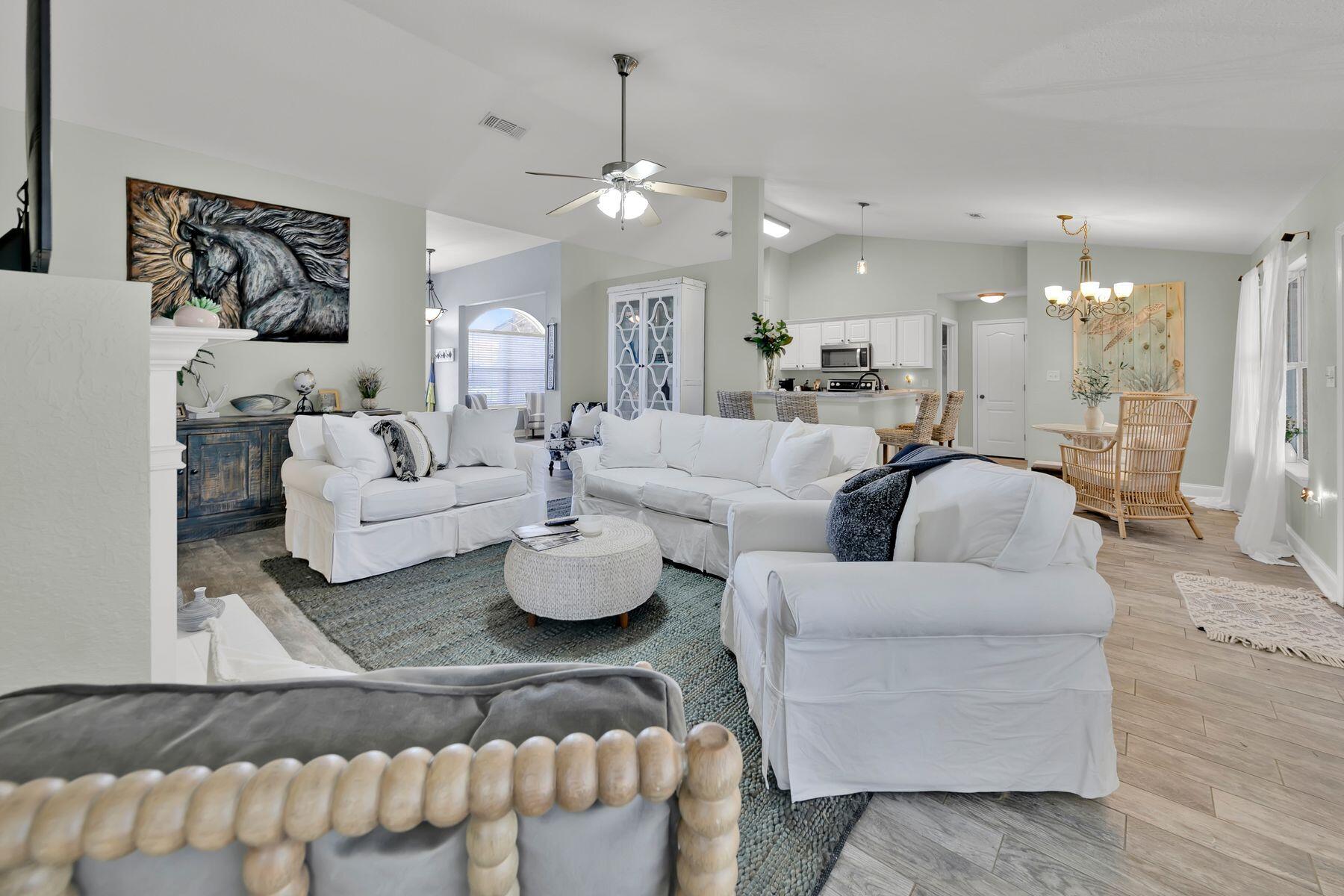 552 East Shipwreck Road Santa Rosa Beach, FL 32459 - Photo 10 of 38 a living room with furniture kitchen view and a chandelier