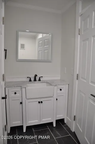 a spacious bathroom with a double vanity sink a mirror and a bathtub