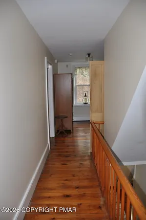 a view of an entryway with wooden floor