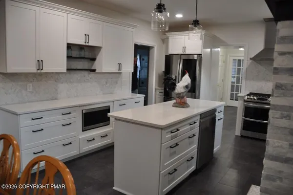 a kitchen with a stove and a refrigerator