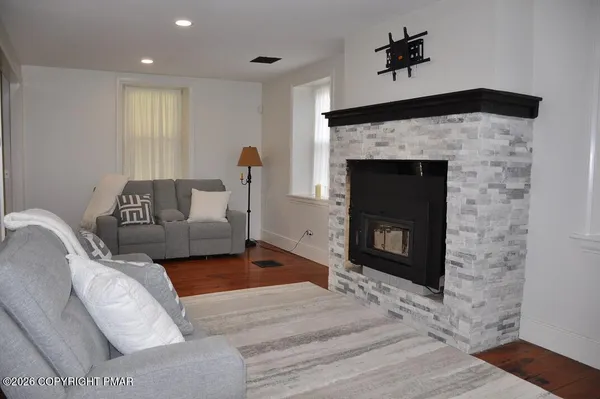 a living room with furniture and a fireplace
