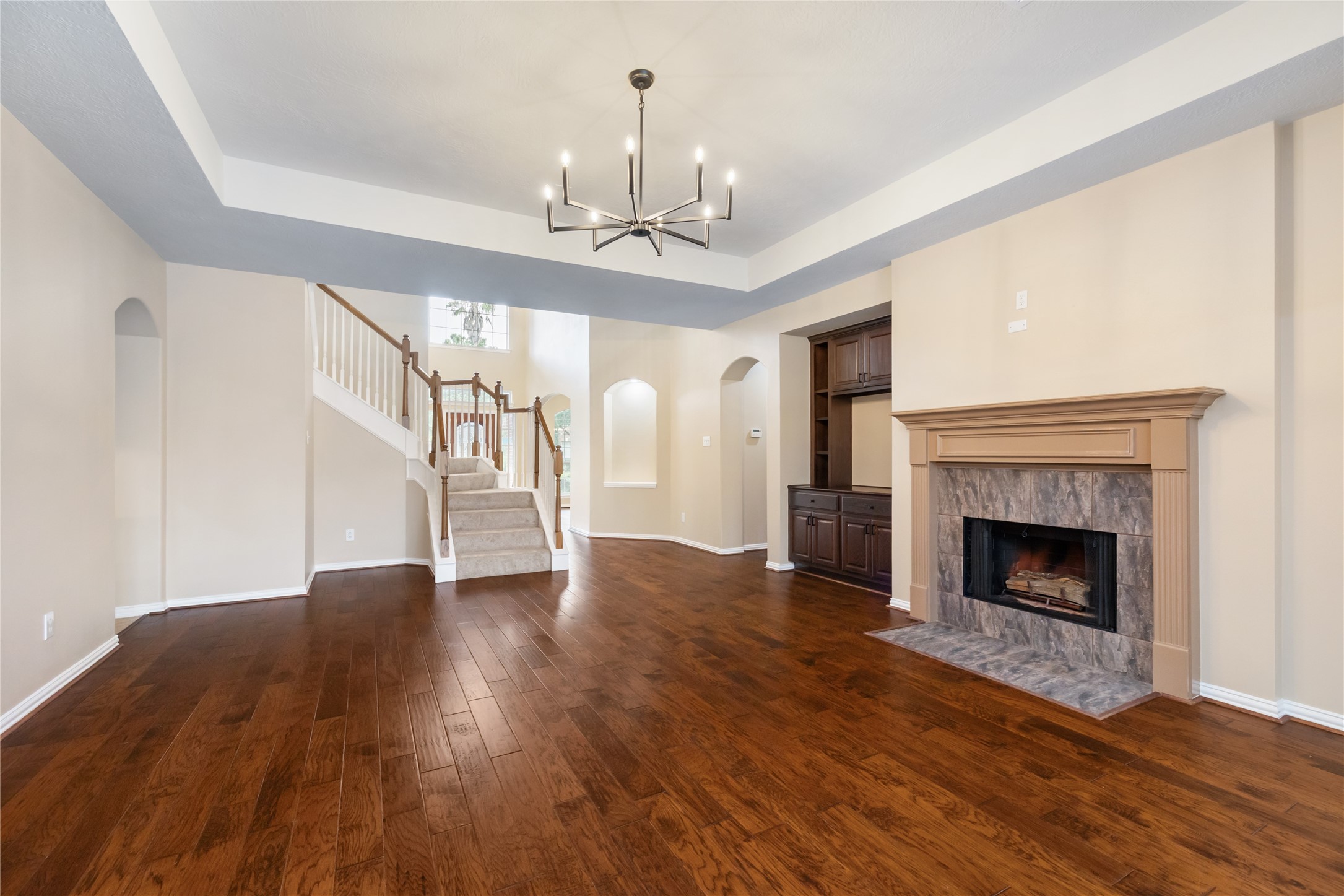 6518 Briarstone Lane Spring, TX 77379 - Photo 11 of 46 The living area features a striking tray ceiling that adds height and character, along with open access to the staircase leading upstairs.