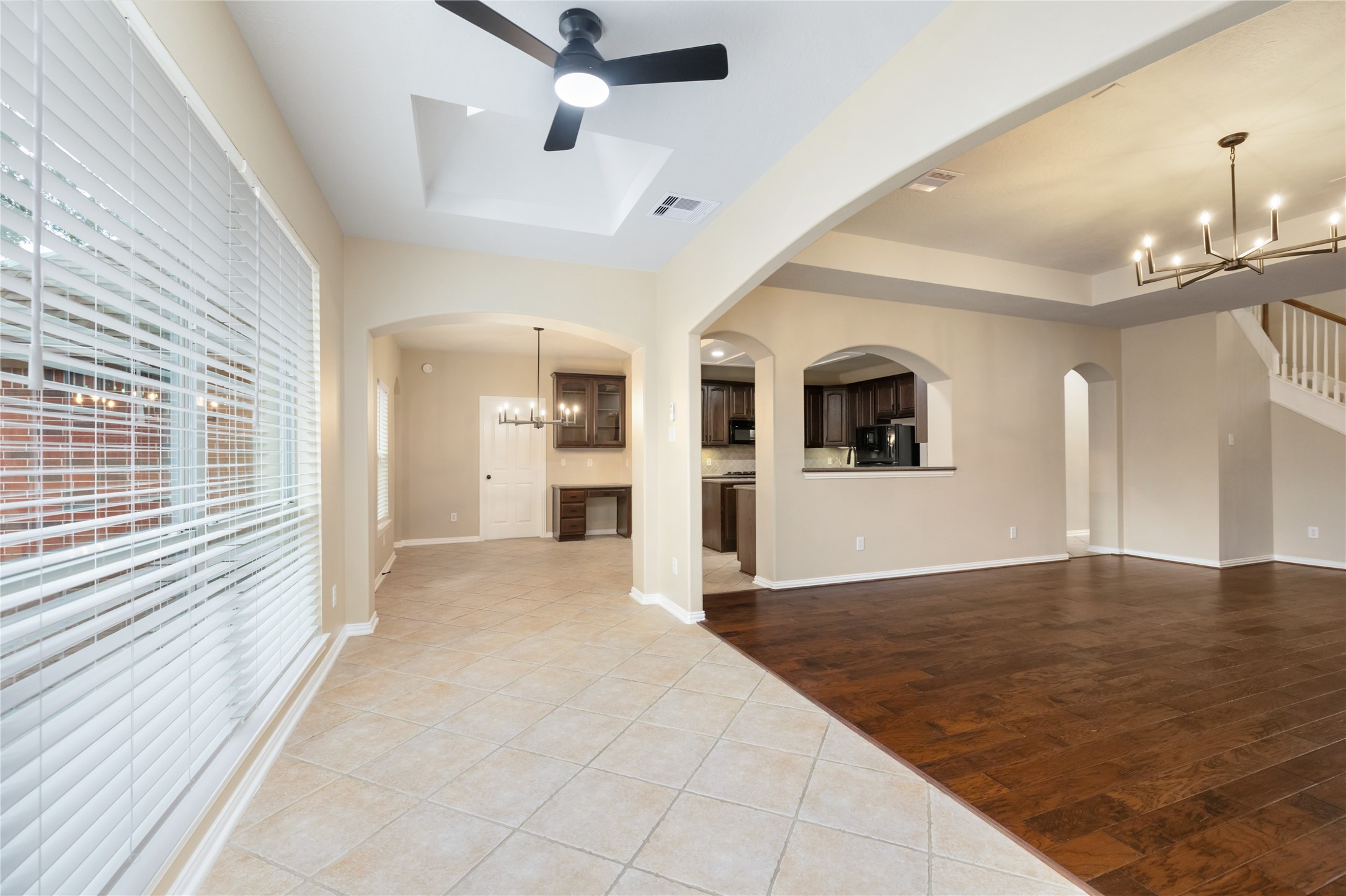 6518 Briarstone Lane Spring, TX 77379 - Photo 12 of 46 Just off the living room, this versatile space features elegant archways, a large window that brings in natural light, a stylish ceiling fan, and convenient access to the kitchen—ideal for a reading nook, play area, or casual dining.