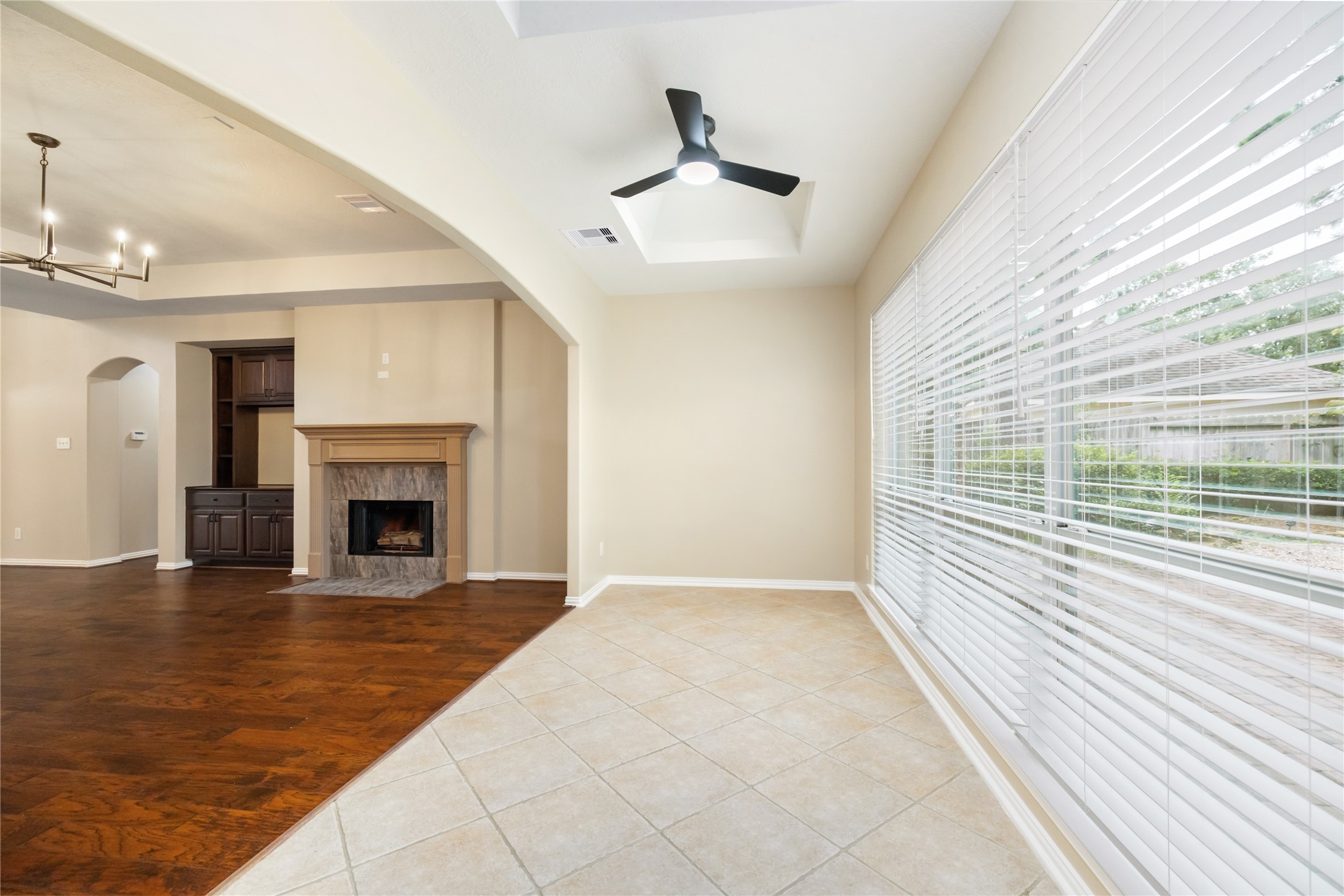 6518 Briarstone Lane Spring, TX 77379 - Photo 13 of 46 Making it a light and connected space within the home, this open-concept space features tile and hardwood flooring and could potentially serve as a creative space, informal dining area, or reading place.