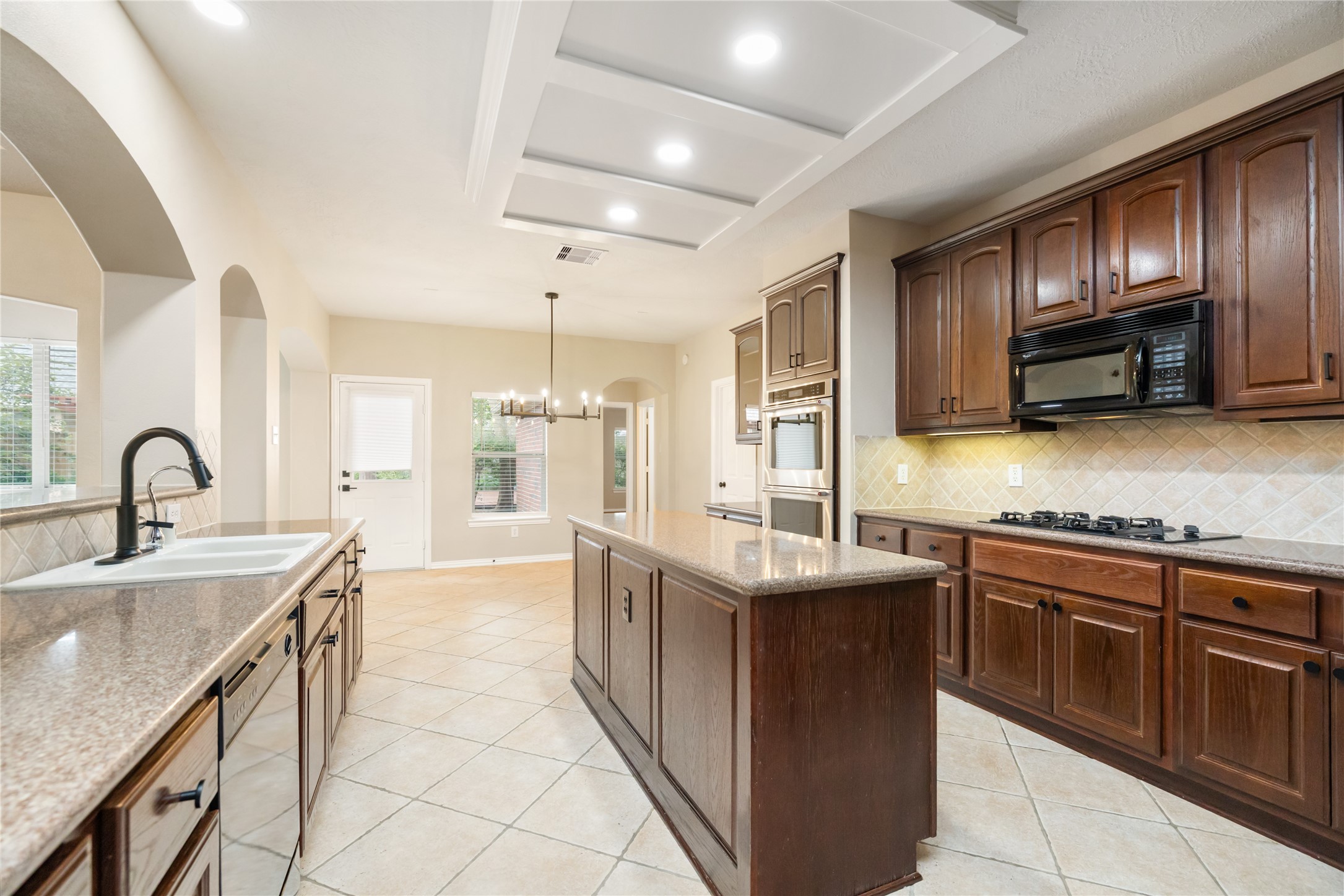 6518 Briarstone Lane Spring, TX 77379 - Photo 15 of 46 Making it ideal for entertaining and everyday gatherings in a naturally lighted environment. A view from this side of the kitchen offers easy access to the connected dining area.