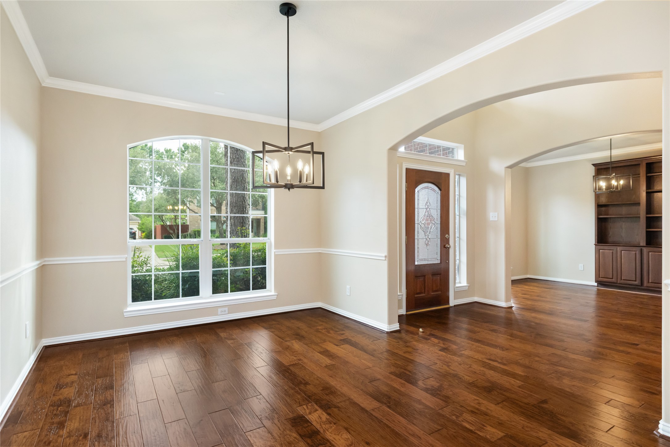 6518 Briarstone Lane Spring, TX 77379 - Photo 7 of 46 Showcasing timeless details, this front room has a magnificent chandelier and wide window all placed beneath an arched opening to the area.